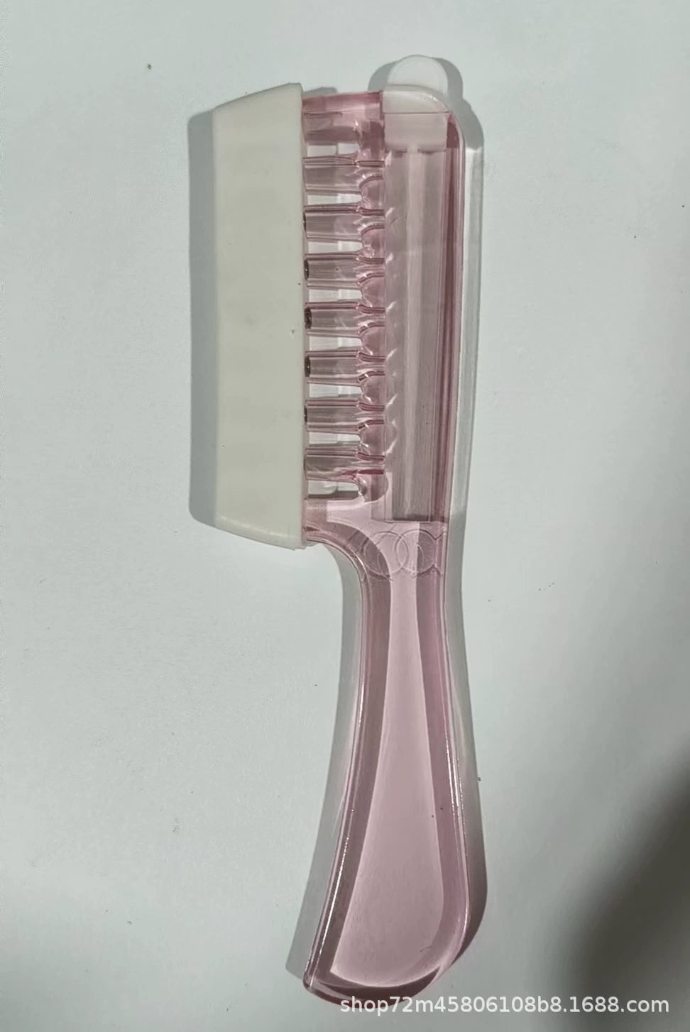 Pink applicator comb with protective cover