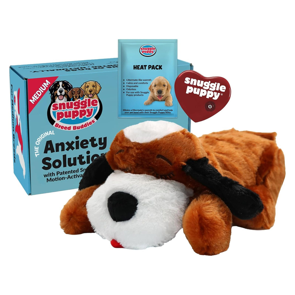 Snuggle Puppy stuffed dog toy in brown and white, shown with its light blue 'Anxiety Solution' product box and a small Heat Pack accessory. A red heart-shaped Snuggle Puppy hang tag is attached to the plush.