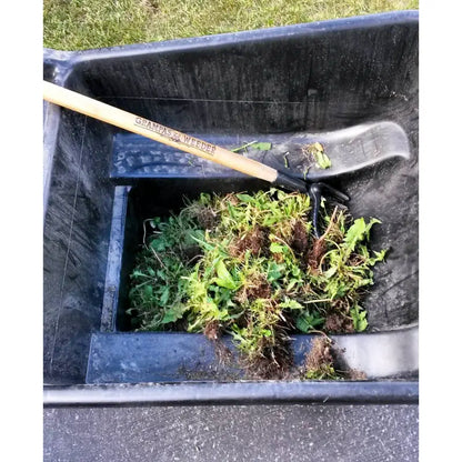 Weed puller beside collected weeds