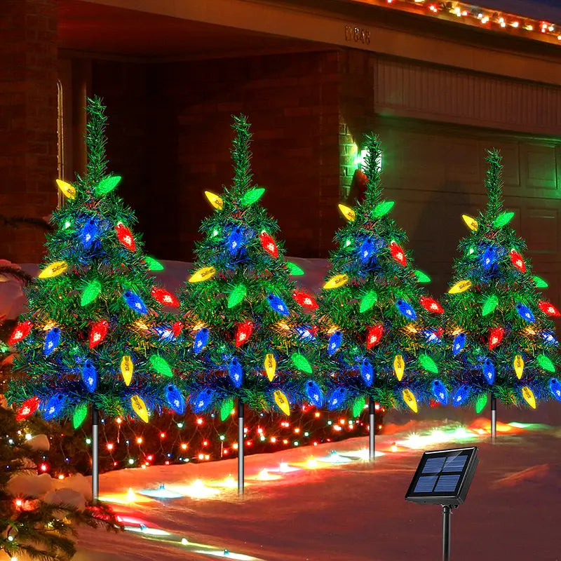 Four solar Christmas tree stake lights with multicolor bulbs