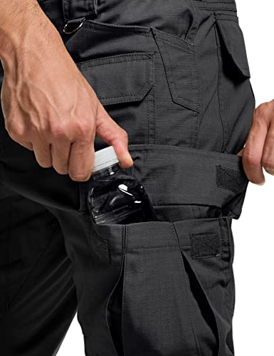 Close-up of dark gray tactical cargo pants showing a side cargo pocket with a water bottle being inserted. Multiple pockets and velcro closures visible on the ripstop fabric.