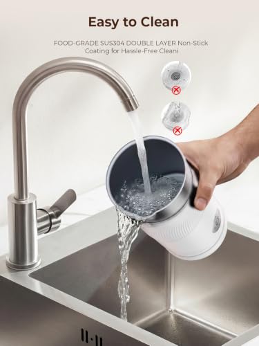 A hand holds a white electric milk frother under a running kitchen faucet, rinsing water into its stainless steel interior over a sink. Text reads 'Easy to Clean' with callouts noting food-grade SUS304 non-stick double layer coating., 3+ more images are available