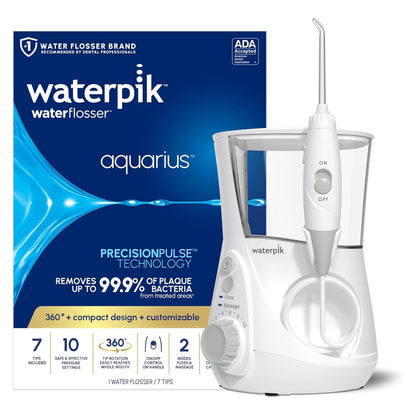 Waterpik Aquarius Water Flosser in white, shown beside its dark blue retail box. Box text highlights PrecisionPulse Technology, removes up to 99.9% of plaque bacteria, 7 tips, 10 pressure settings, and ADA Accepted seal.