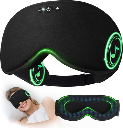 Black 3D contoured sleep mask with Bluetooth headphones, shown from front and back. Features glowing green speaker indicators, control buttons on top, and an adjustable strap. Lifestyle inset shows a woman wearing it.