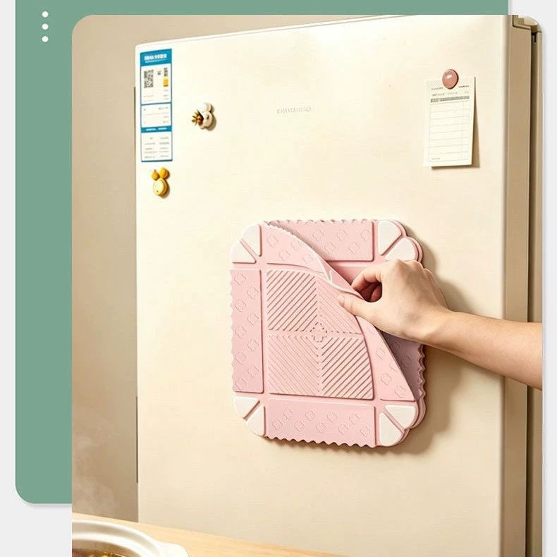 Foldable mat held magnetically against a refrigerator