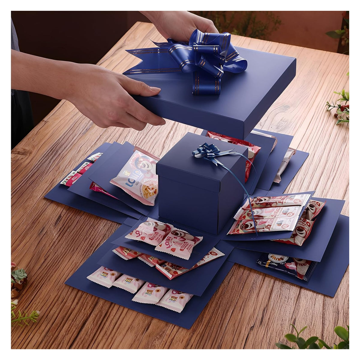 Blue five-layer surprise box opening example; decorative contents, cash and photos are not included.