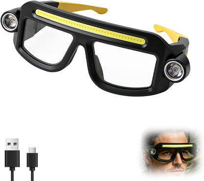 Black and yellow LED headlight glasses with two spotlight LEDs on outer corners and a COB strip light along the top frame. Clear lenses, yellow temples. Includes USB-C charging cable and inset photo of glasses being worn.